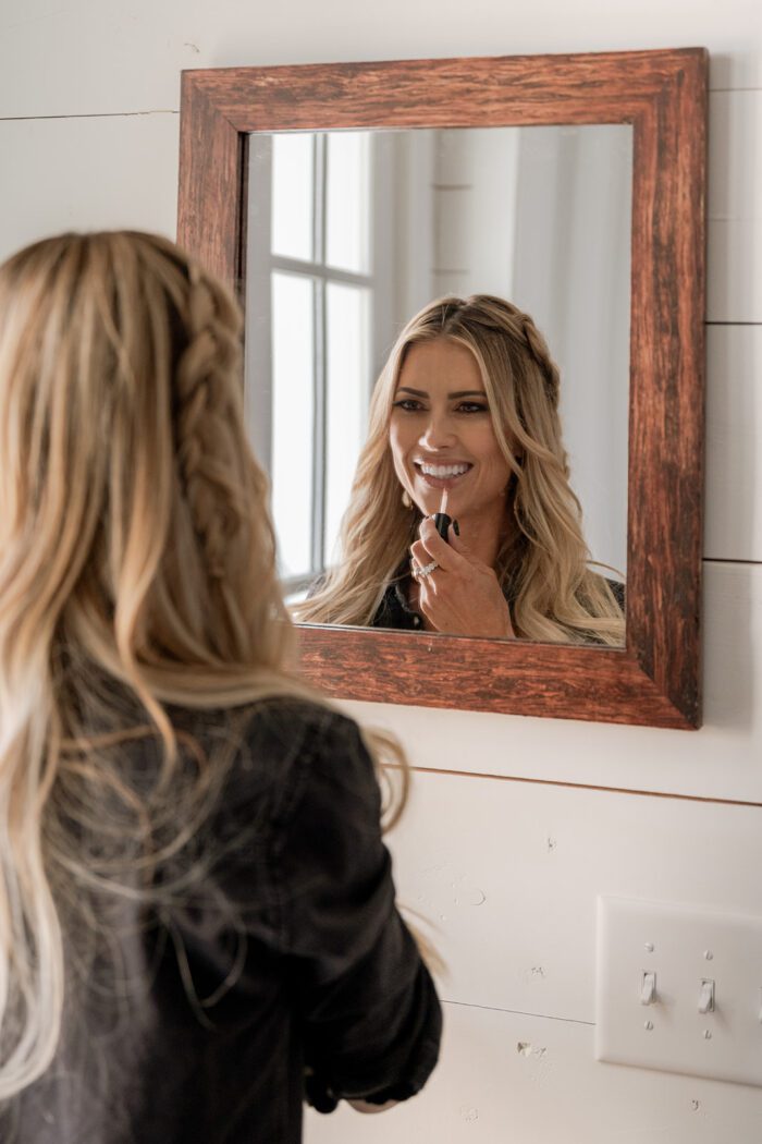 lady in hemp mirror putting on lipstick